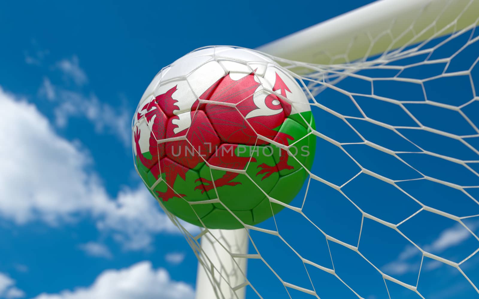 Wales flag and soccer ball in goal net by Barbraford