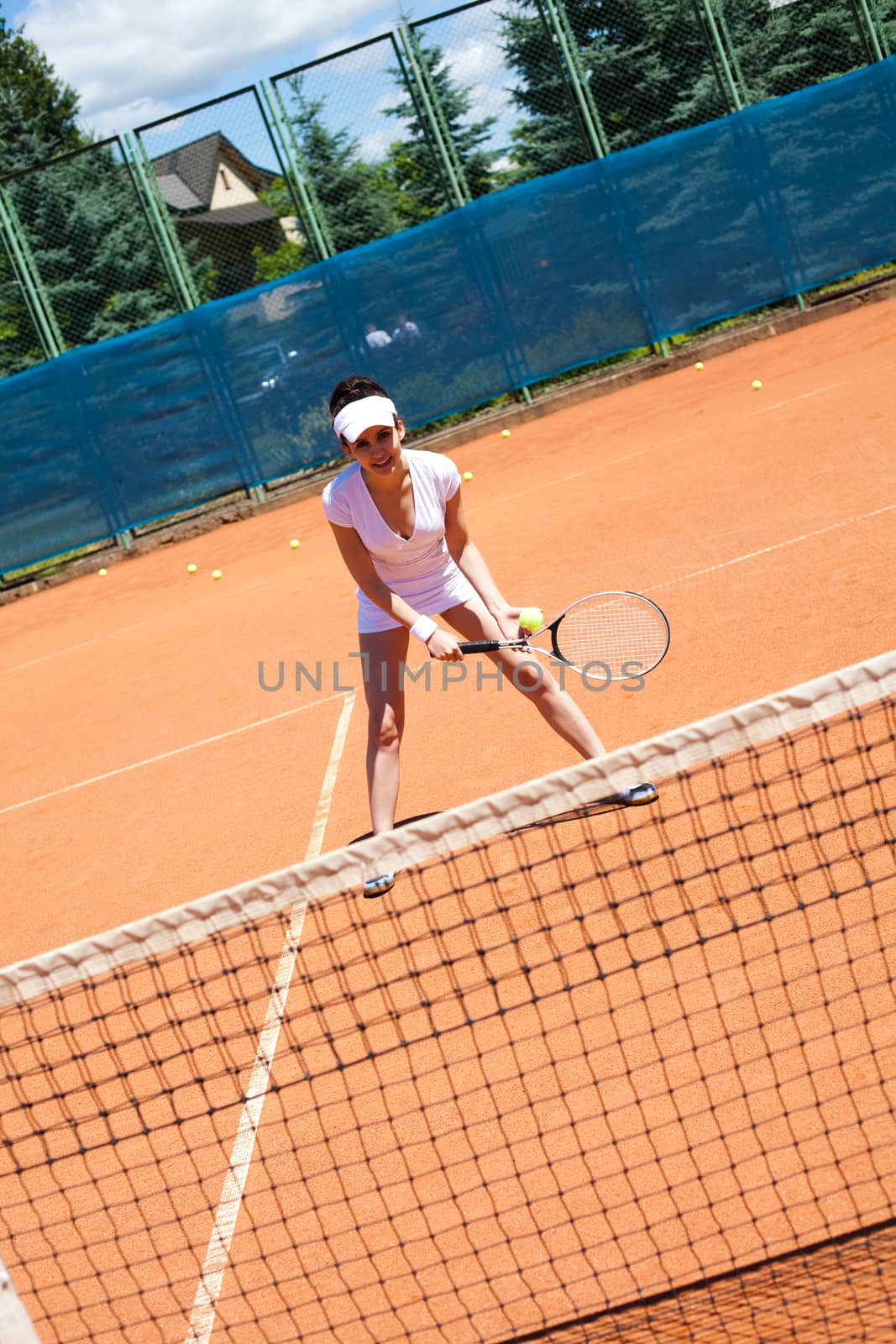 Woman playing tennis, summertime saturated theme by JanPietruszka