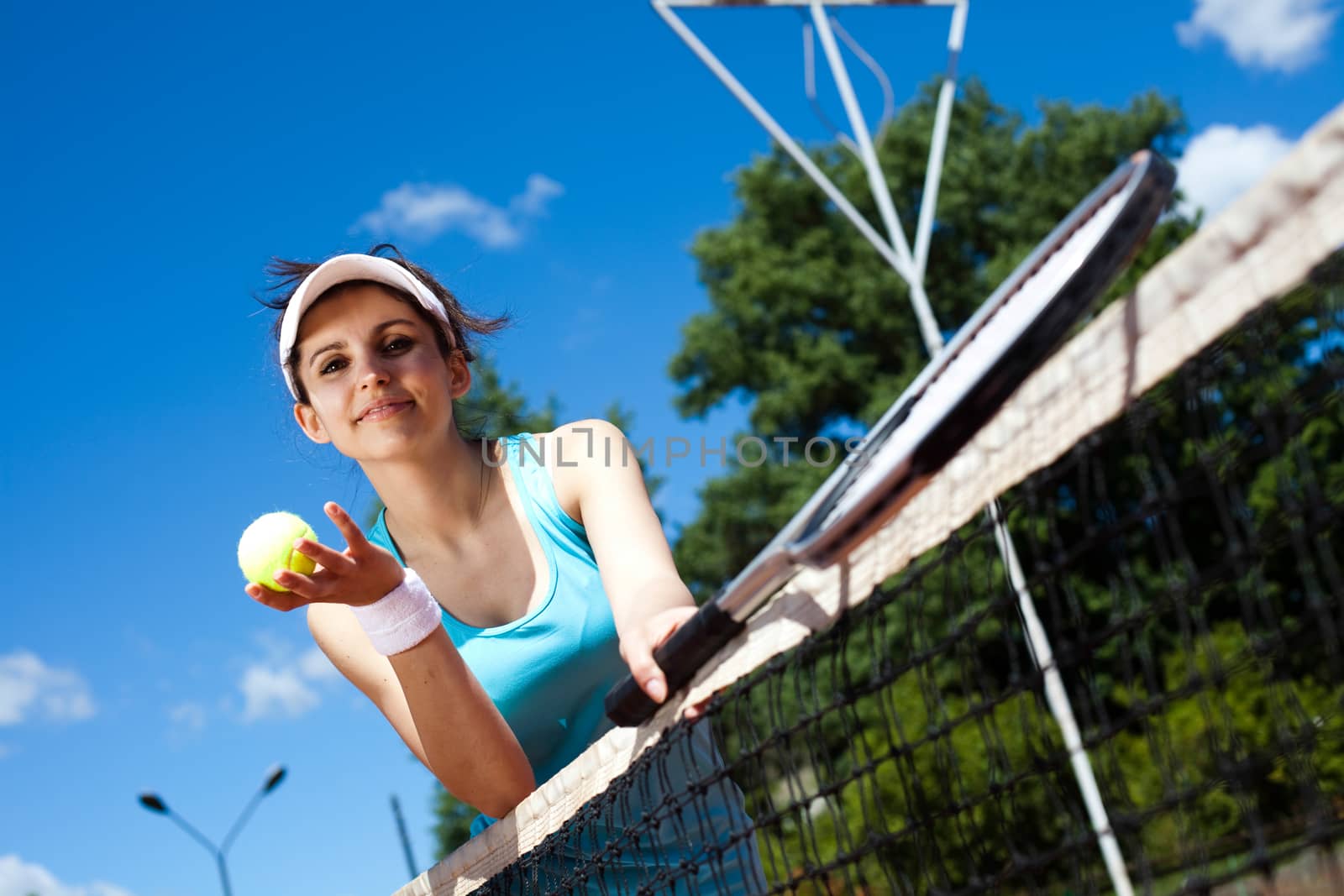 Woman playing tennis, summertime saturated theme