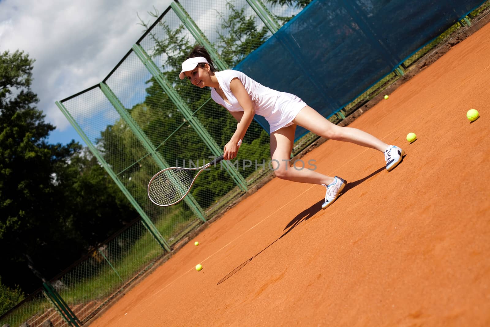 Girl playing tennis on the court