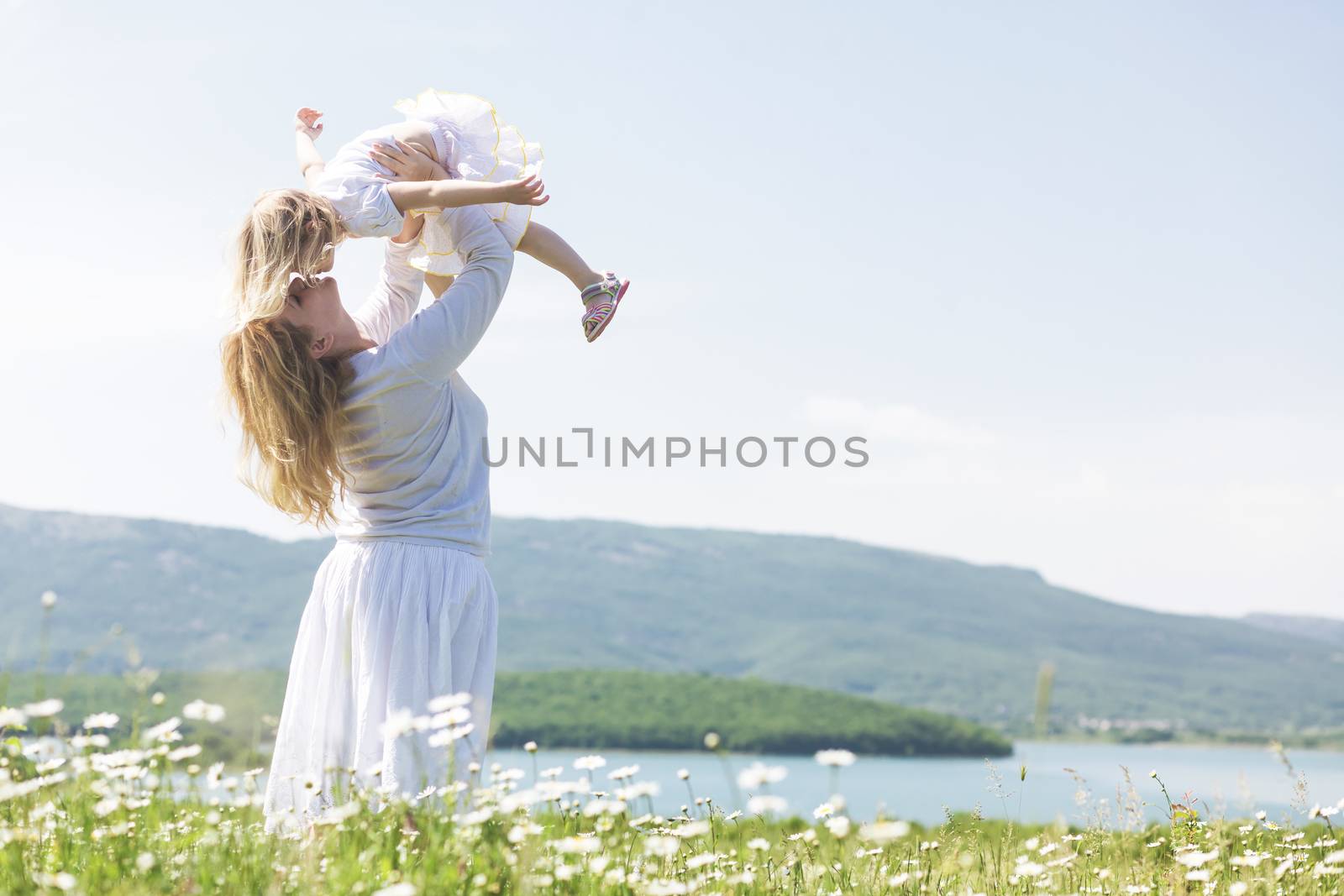 Family in the flower field by alenkasm