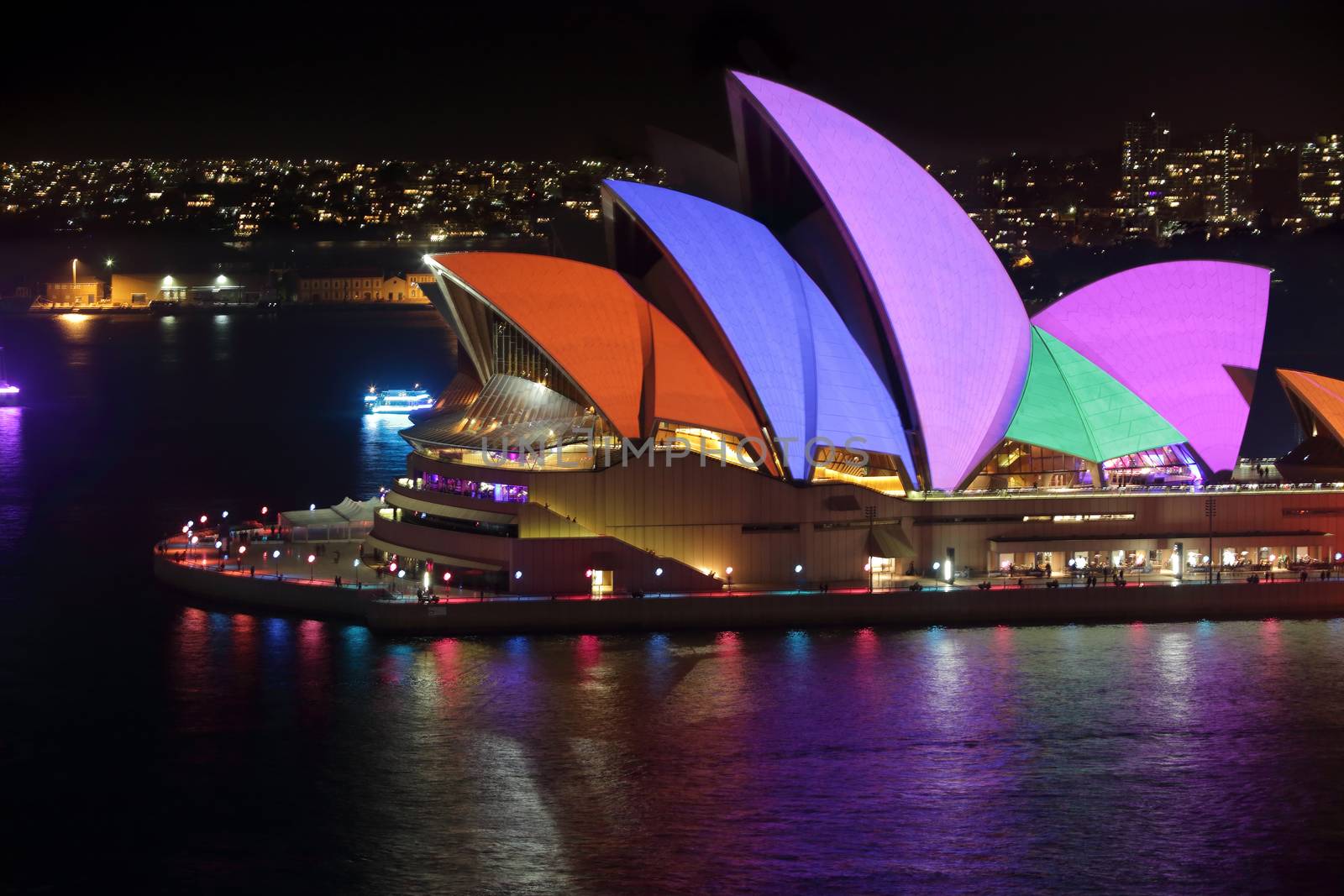 SYDNEY, AUSTRALIA - MAY 23, 2015; Sydney Opera House illuminated with colourful animated imagery during the Vivid Sydney 2015 annual public event.  Vivid solid colours of red, blue, pink, green and orange on display.