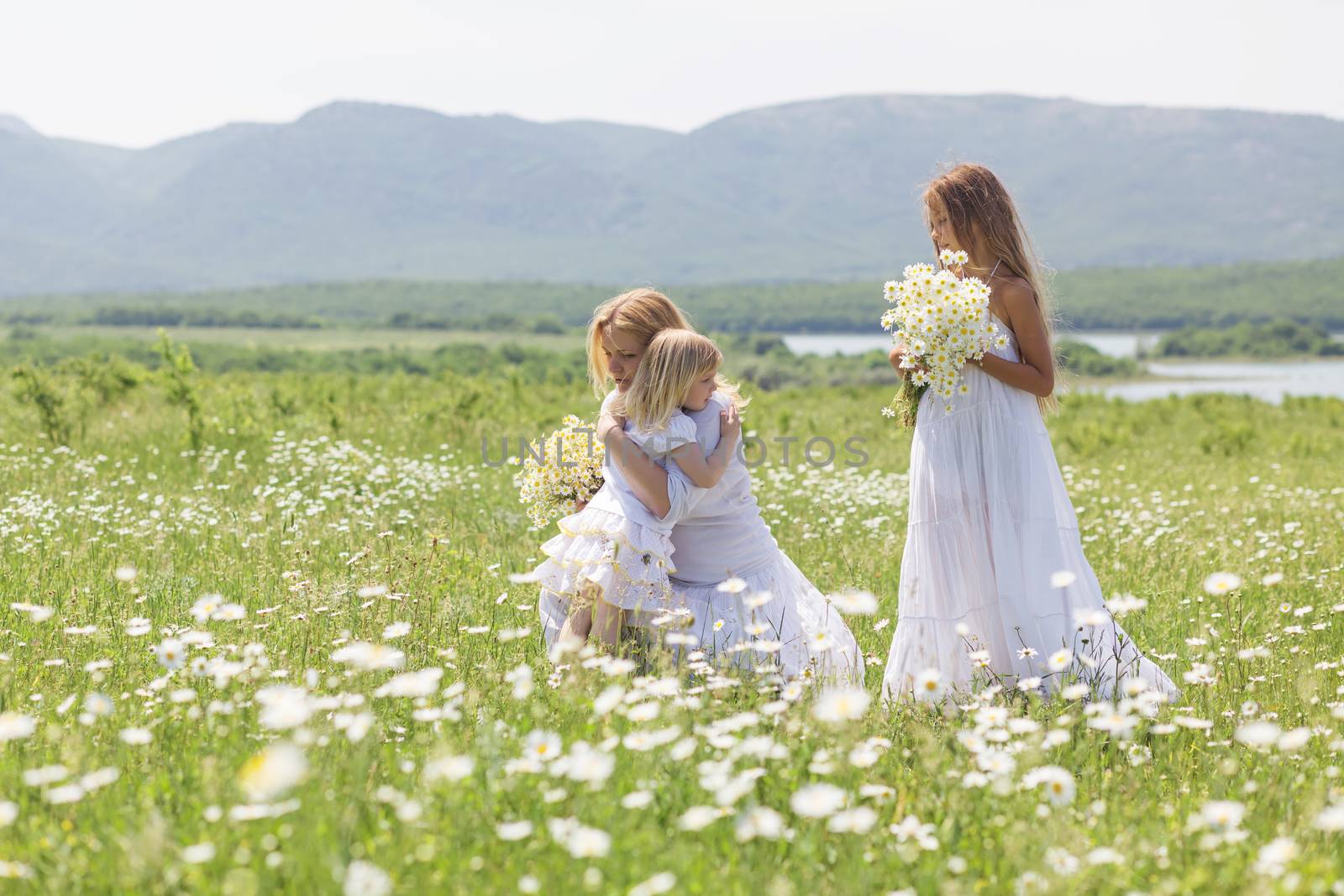 Family in the flower field by alenkasm