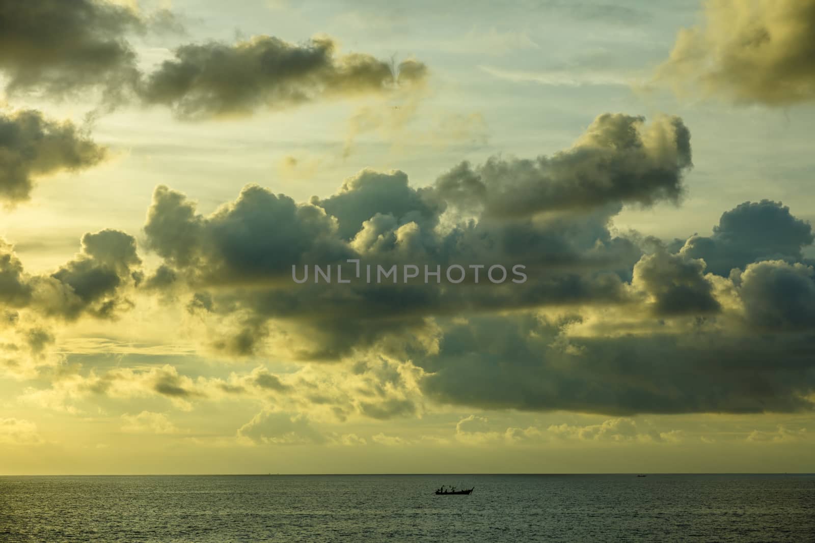Lonely boat in the ocean before sunset