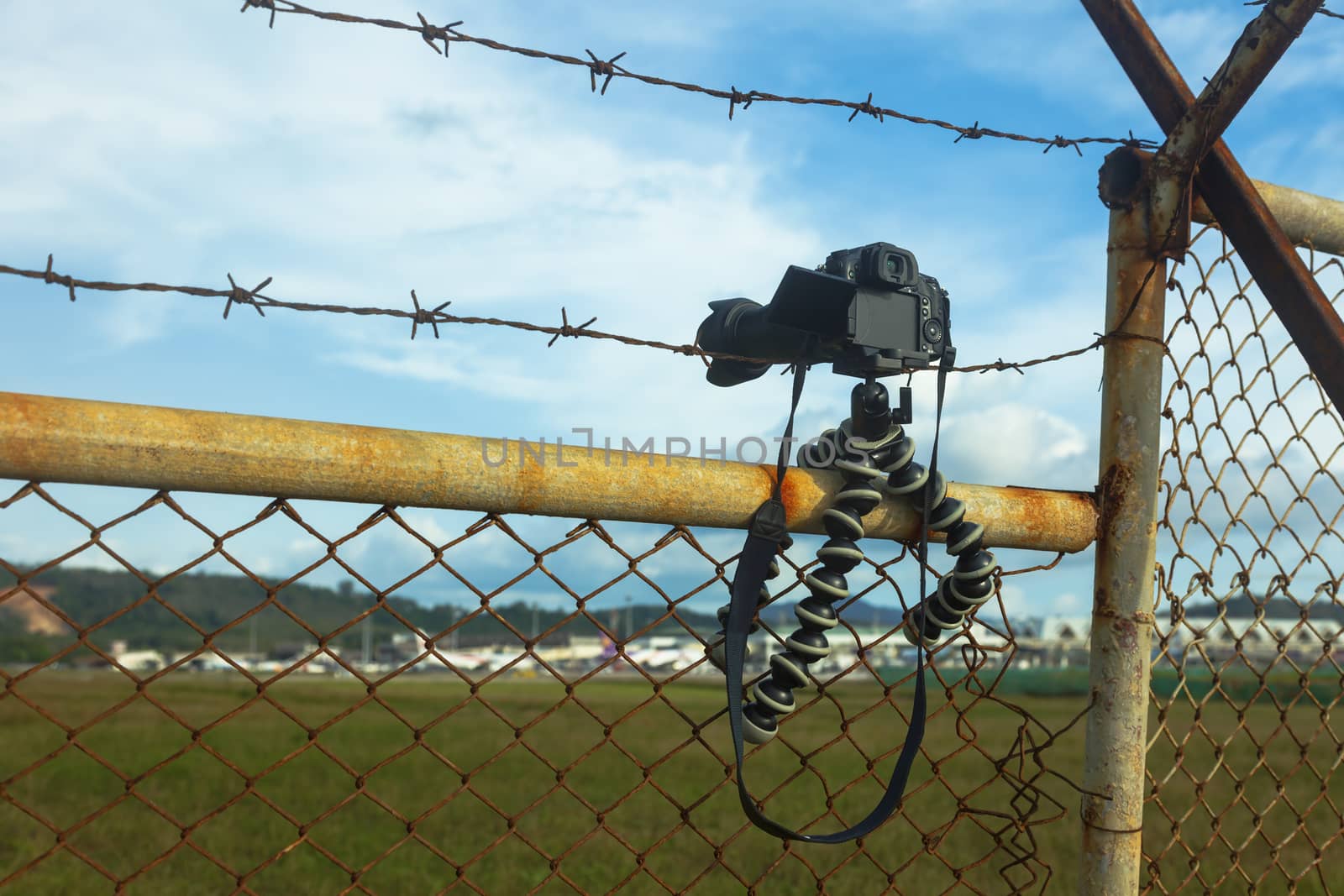Camera on the fence shooting airplane takeoff