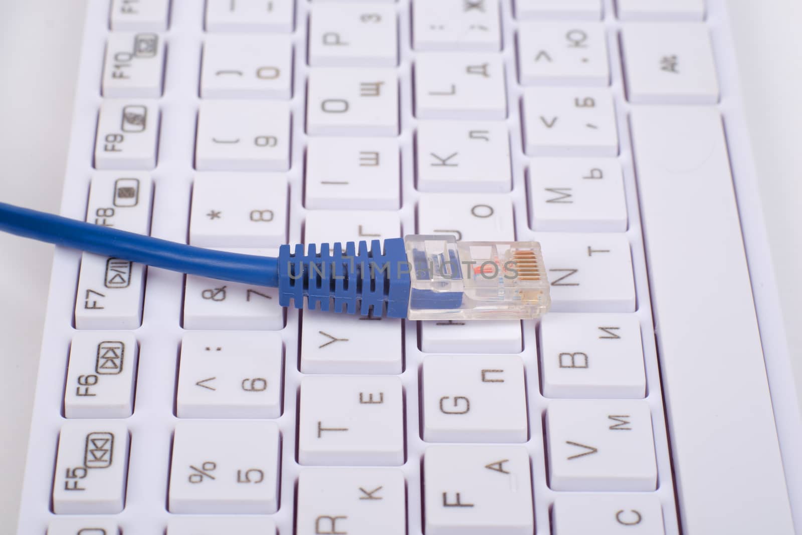 Blue computer cable on keyboard, close up view