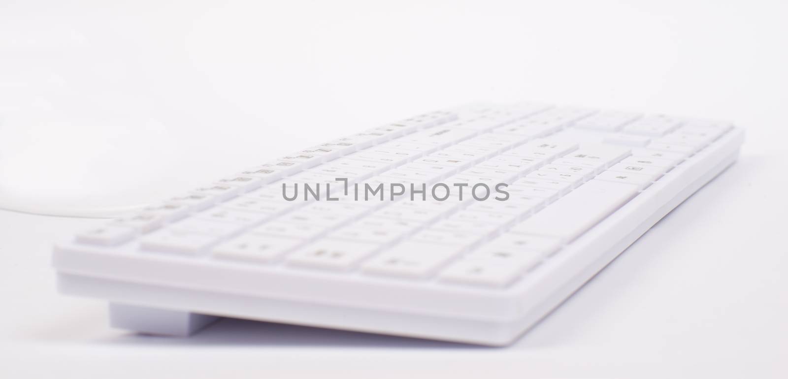 White keyboard with wire on isolated white background, different view