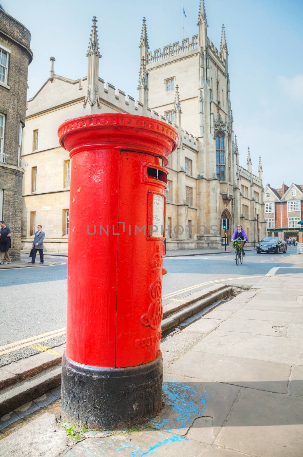 Cambridge, UK - April 9: Famous red post box in Cambridge, UK. It's a physical box into which members of the public can deposit outgoing mail intended for collection by the agents of a country's postal service.