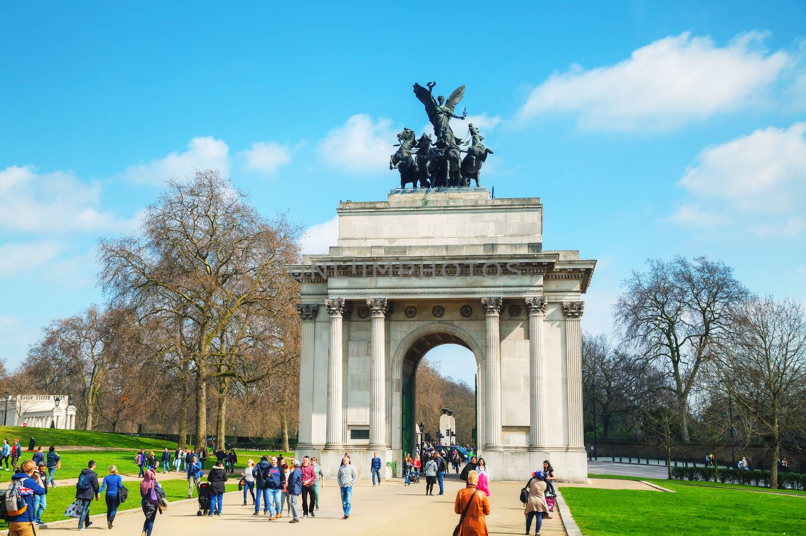 LONDON - APRIL 6: Wellington Arch monument with people on April 6, 2015 in London, UK. It's a triumphal arch located to the south of Hyde Park in central London and at the western corner of Green Park.