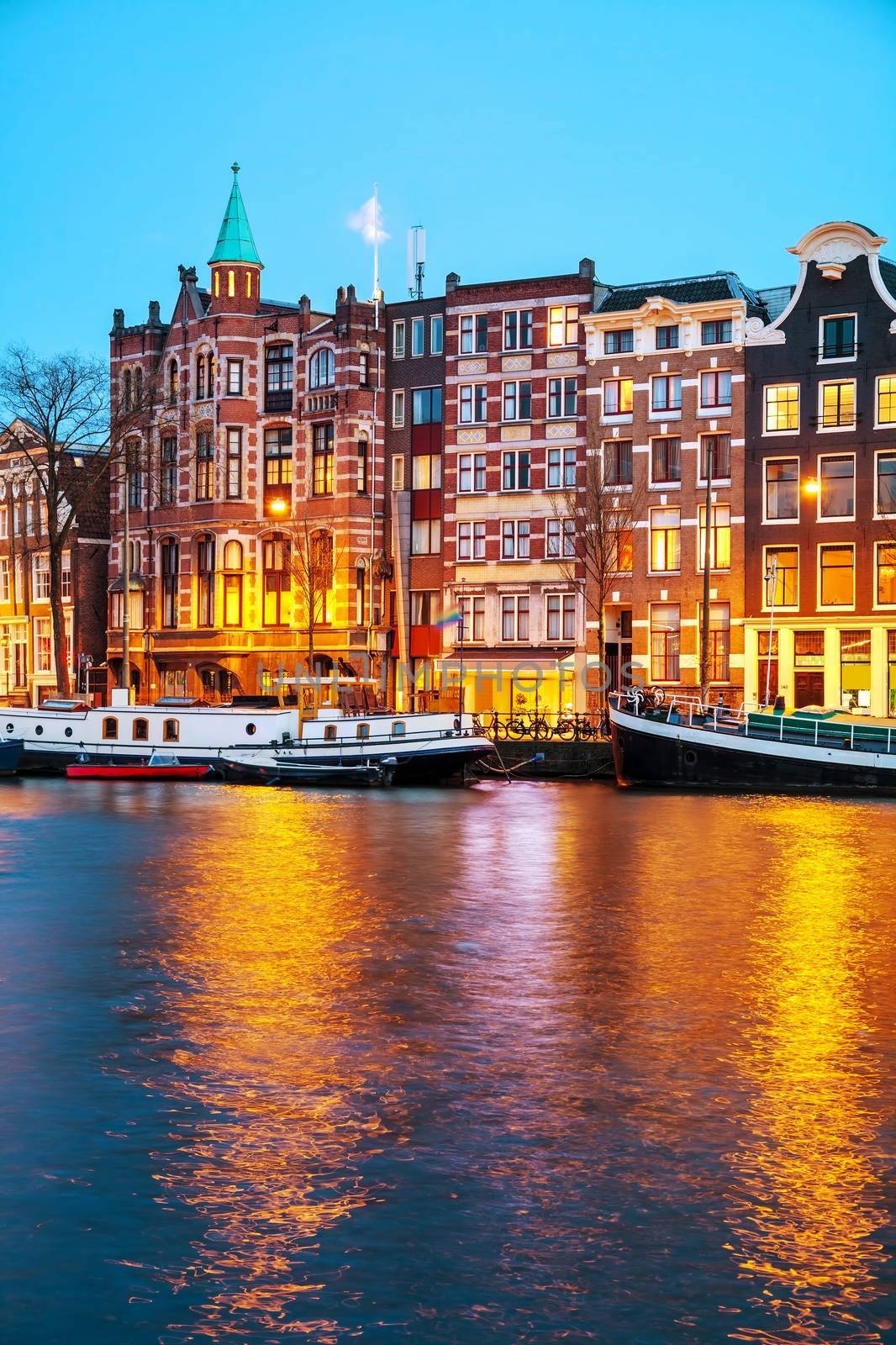 Night city view of Amsterdam, the Netherlands with Amstel river