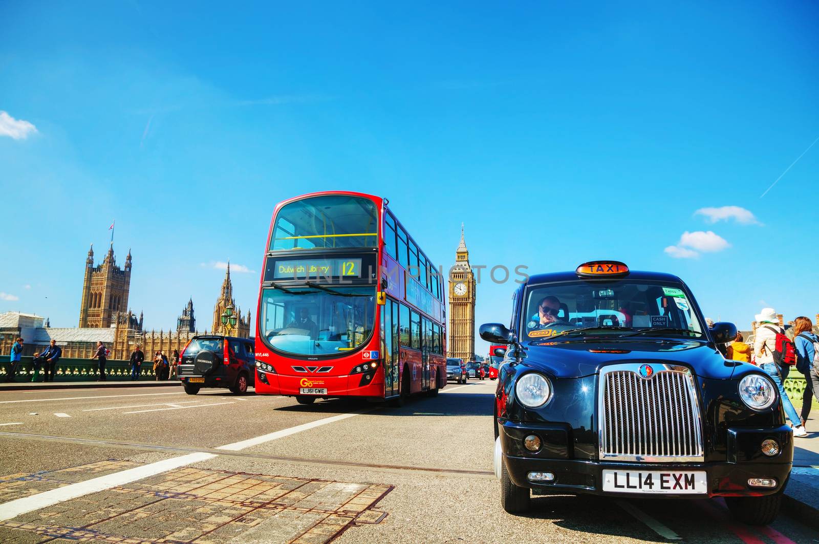 LONDON - APRIL 6: Famous taxi cab (hackney) on a street on April 6, 2015 in London, UK. A hackney or hackney carriage (a cab, black cab, hack or London taxi) is a carriage or automobile for hire.