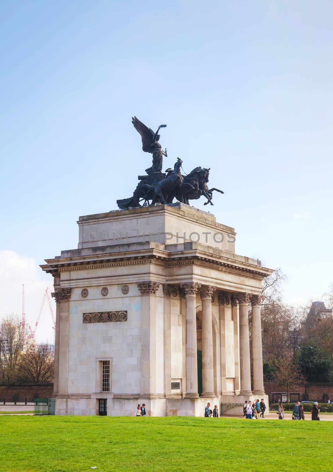 LONDON - APRIL 6: Wellington Arch monument with people on April 6, 2015 in London, UK. It's a triumphal arch located to the south of Hyde Park in central London and at the western corner of Green Park