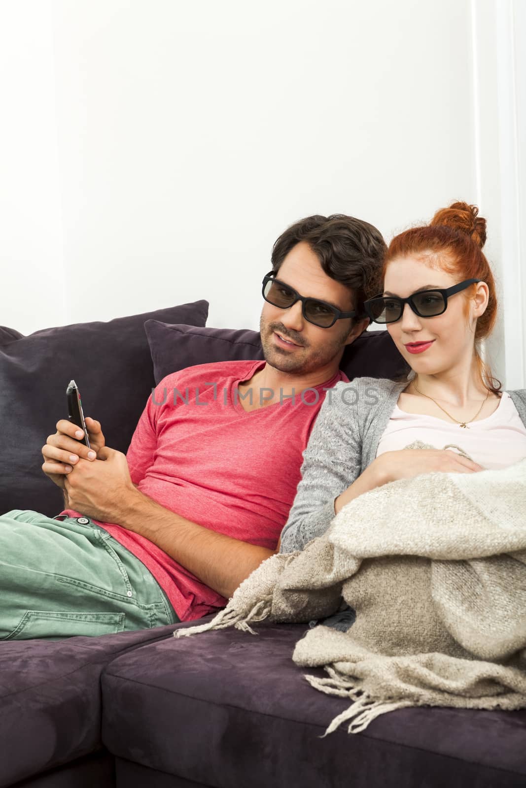 Close up Happy Young Sweethearts Wearing Sunglasses Resting on the Sofa at the House Living Room.