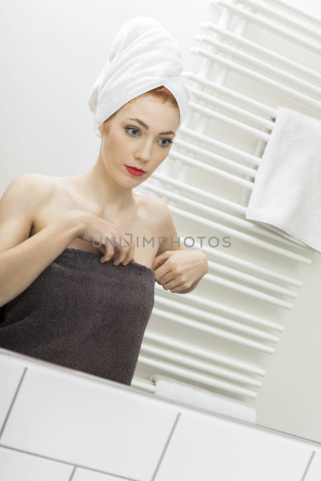 Close up Fresh Young Woman From Shower Looking her Face While Touching it In Front the Mirror