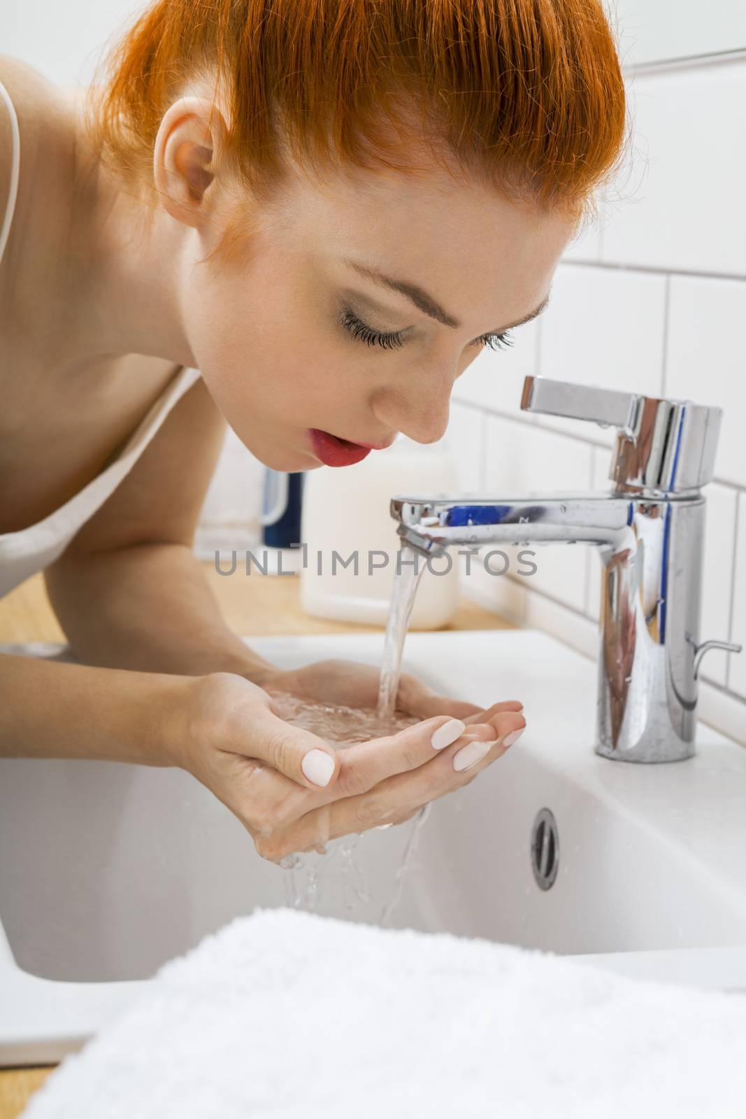 Woman Washing her Face While Looking at the Camera by juniart