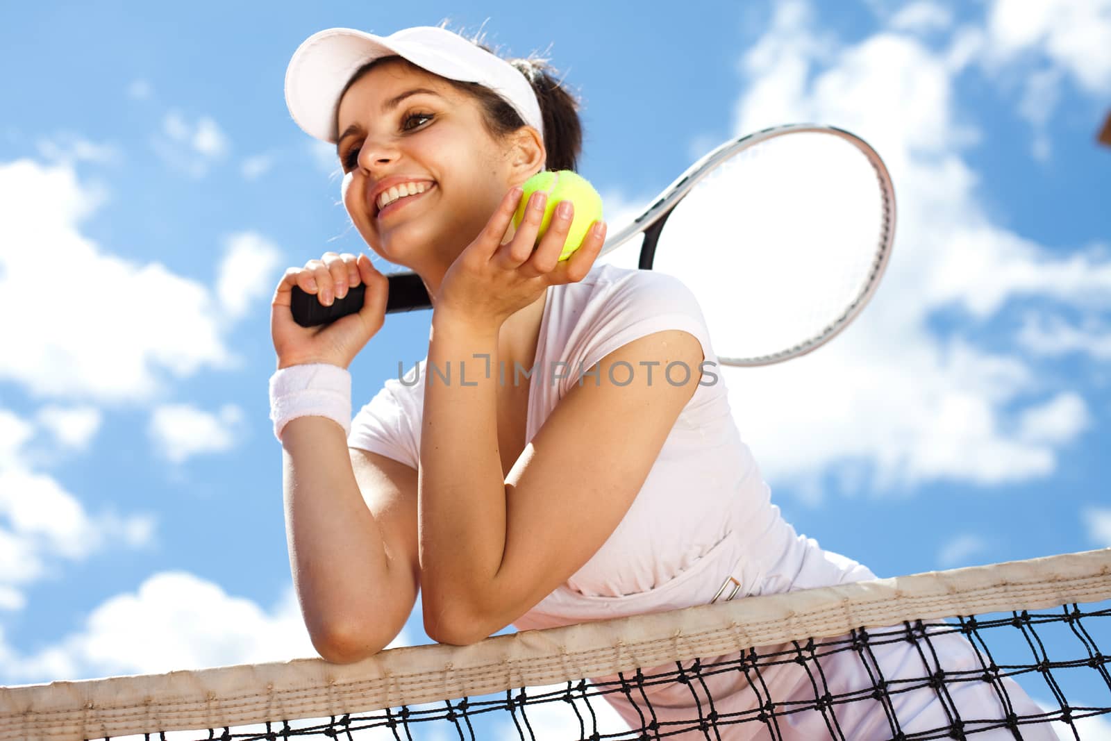 Woman playing tennis in summer by JanPietruszka