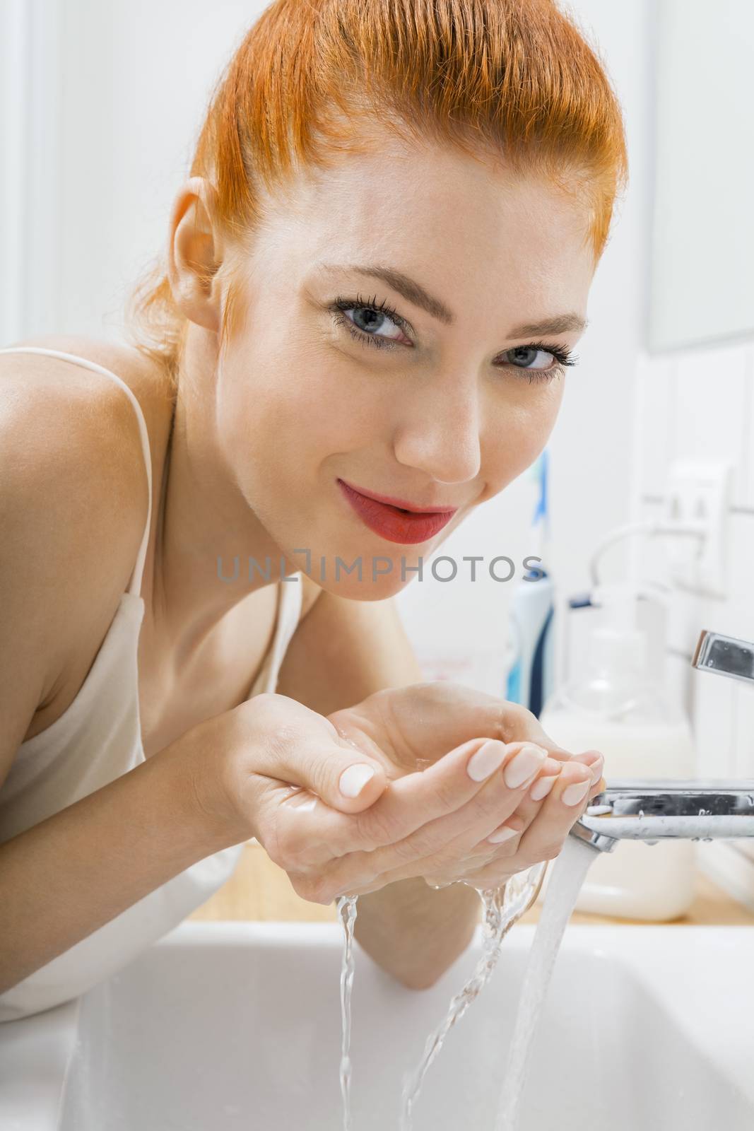 Woman Washing her Face While Looking at the Camera by juniart