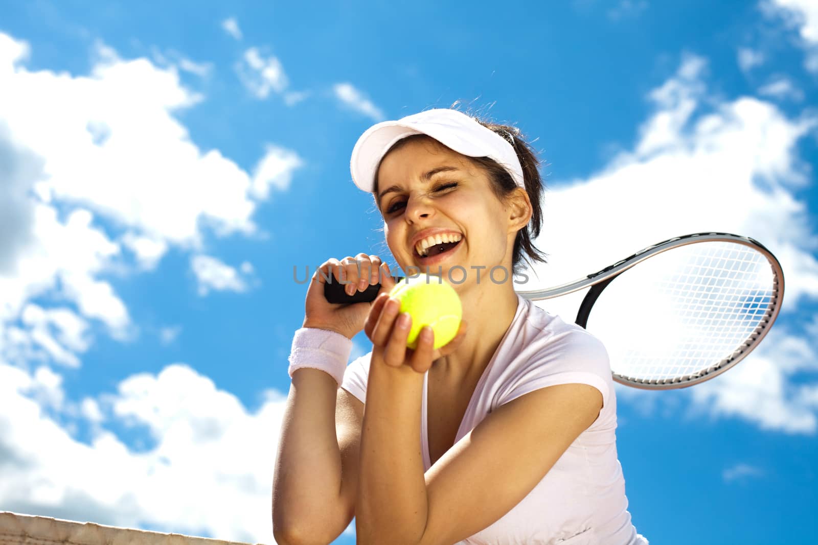 Woman playing tennis in summer by JanPietruszka