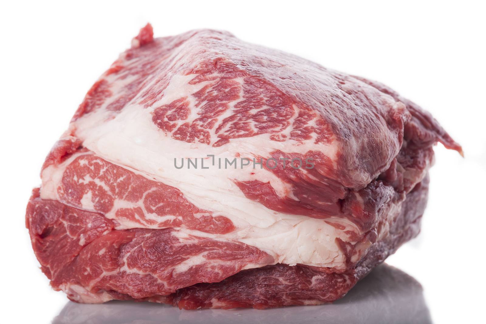 Fresh Slice of Protein Rich Raw Beef Meat on Top of the Table on White Background