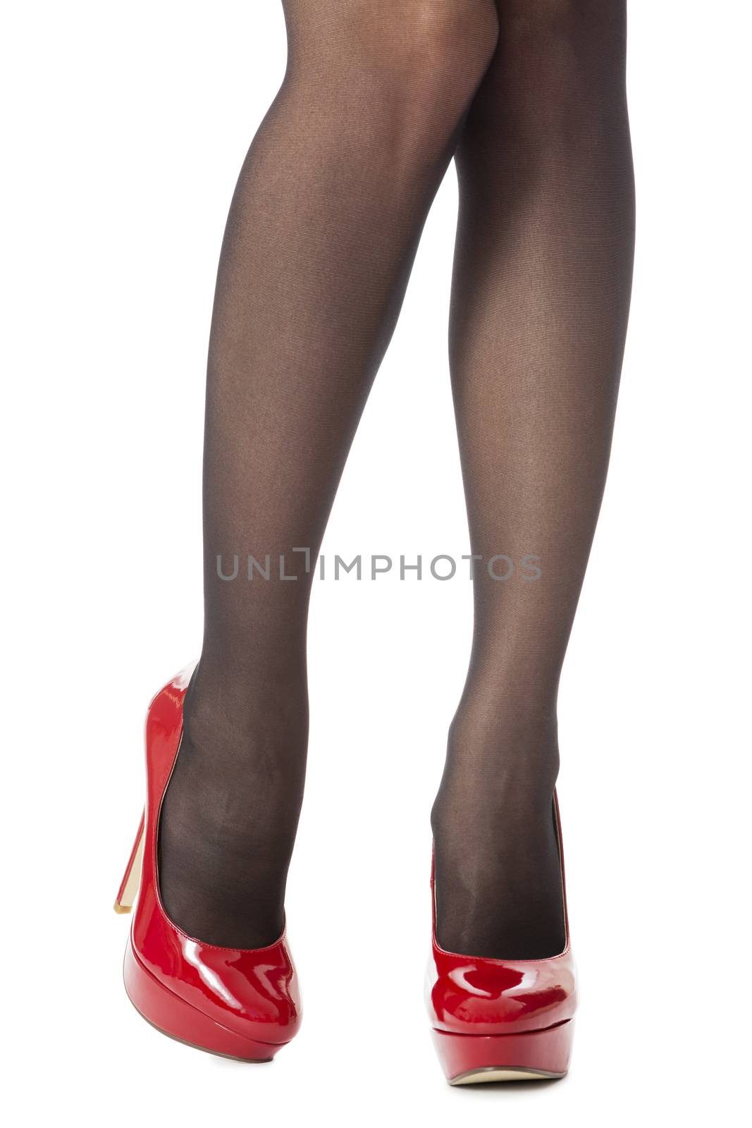 Close up Sexy Woman Legs Wearing Glossy Red High Heel Shoes and Gray Stockings. Isolated on White Background.