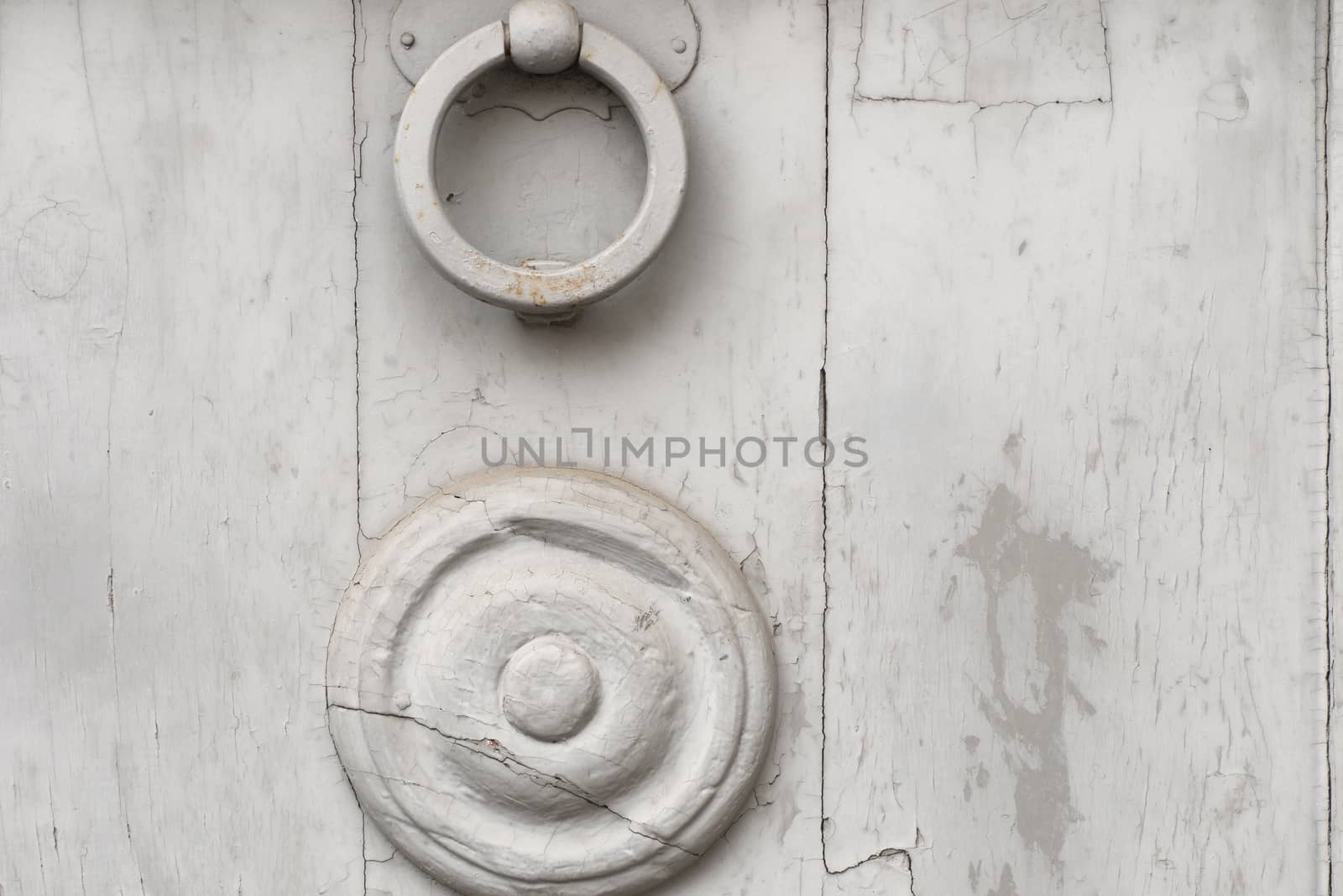 Detail embossed metal handle and an old door
