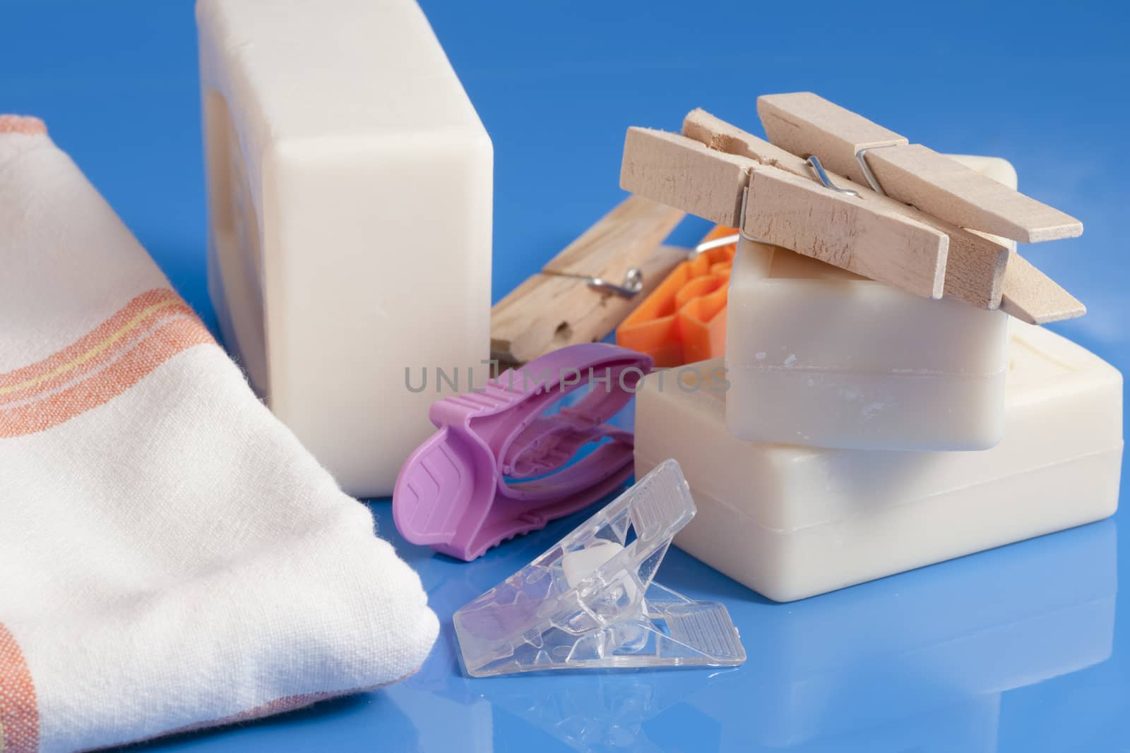 soap and clothespins put on a clean a light blue background