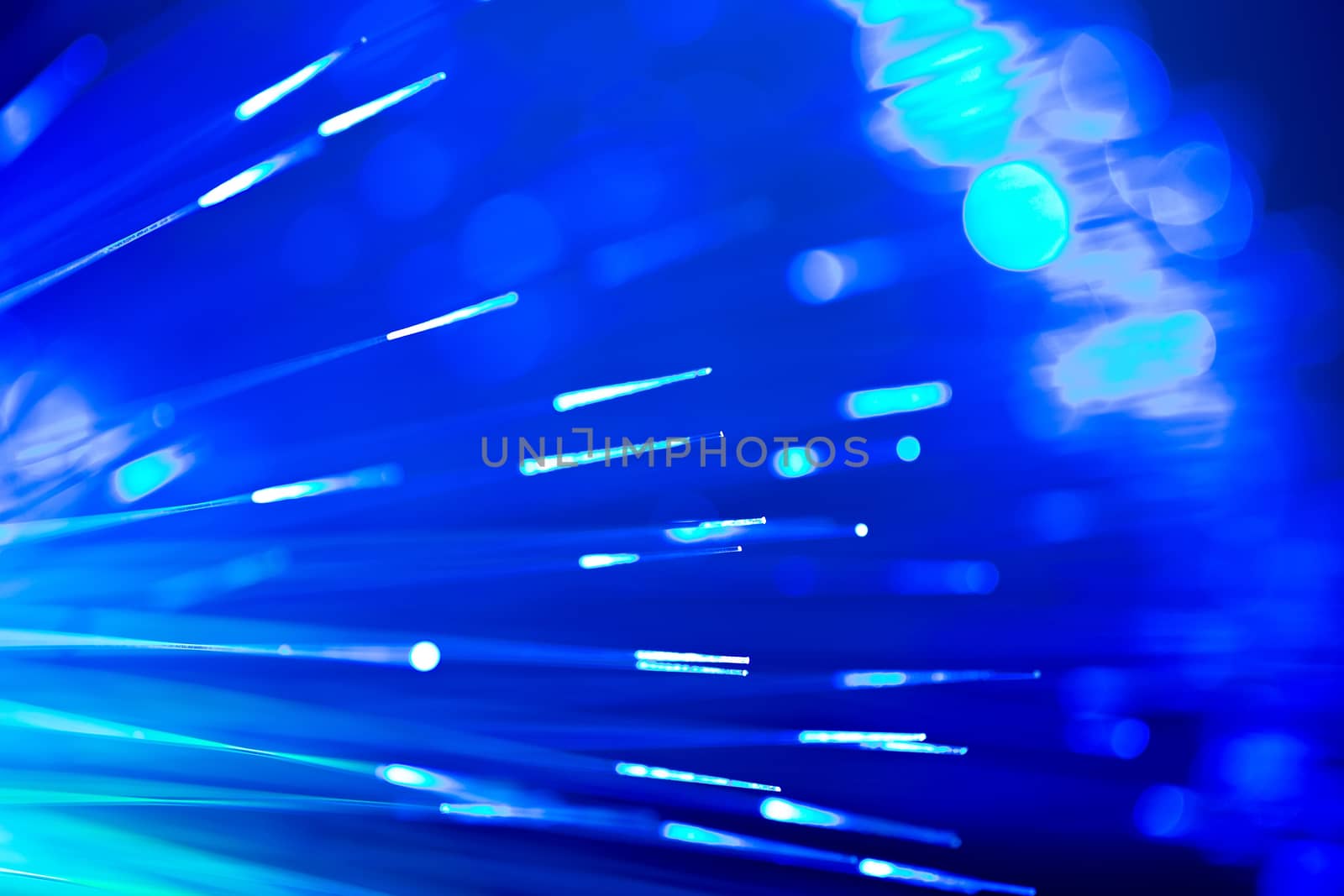bunch of optical fibres flying from deep as blurred abstract technology background
