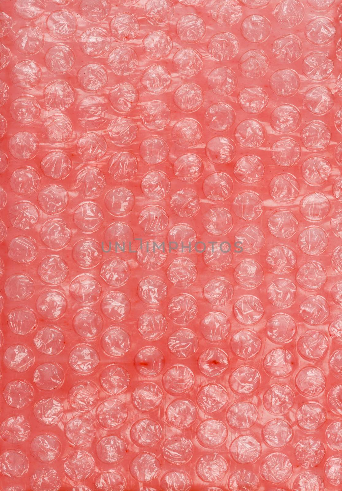 Air-bubble wrap texture on red background, close-up view