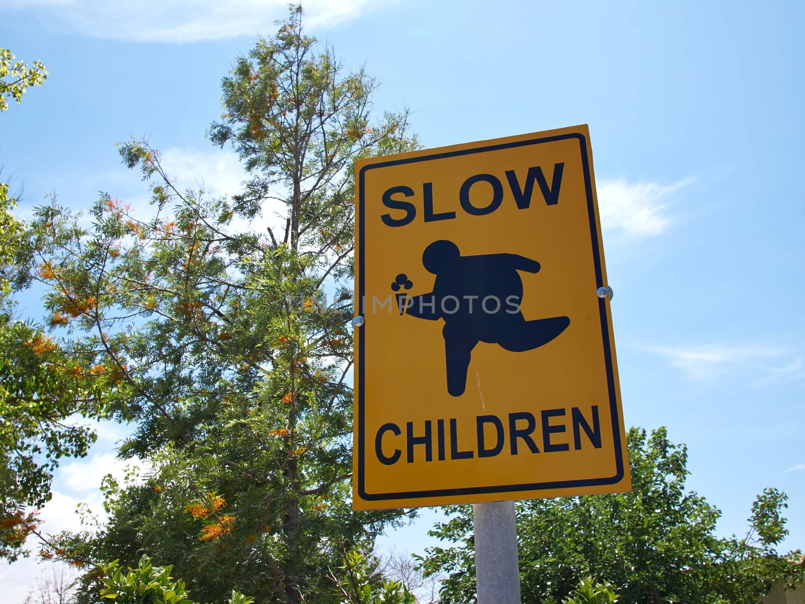 Slow Children at Play street sign with blue sky background