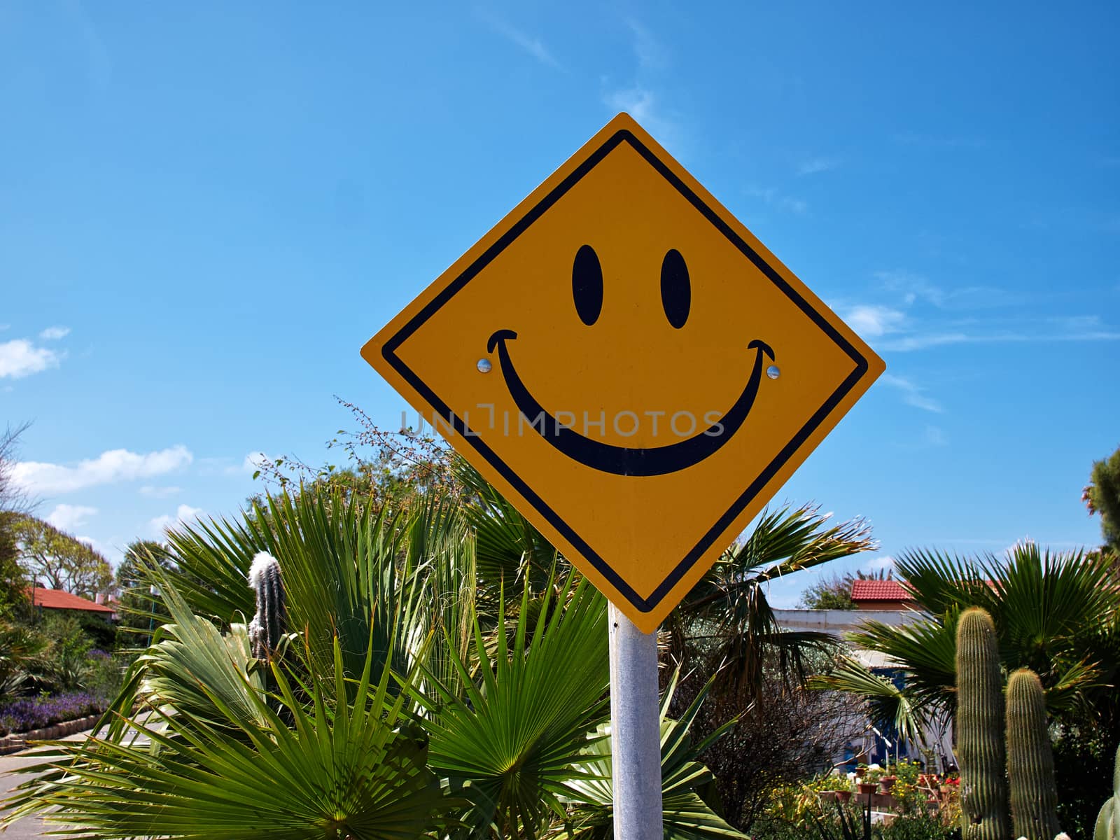 Conceptual funny road sign with a smiley face with clear blue sky background