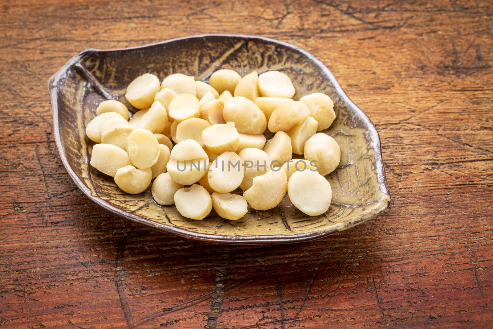macadamia nuts on leaf bowl by PixelsAway