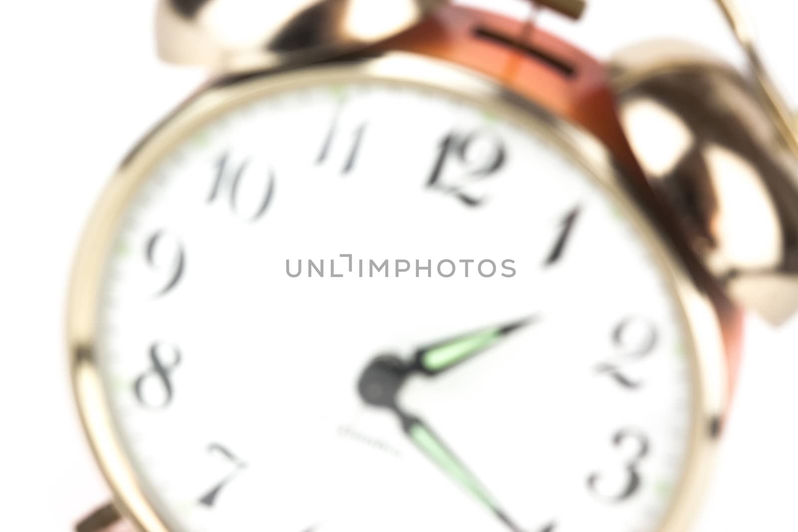 Close up of an alarm clock on a white background - blurred