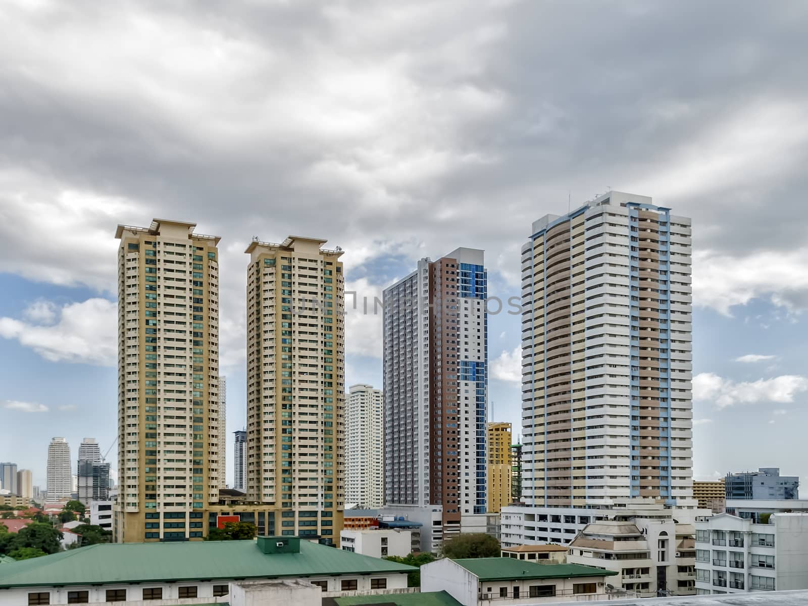 Dark clouds over tall buildings in Manila, Philippines