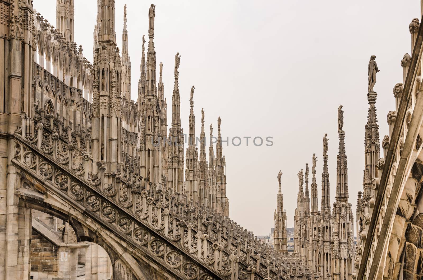 Detail view of stone sculptures on roofs of Duomo Milano, Italy