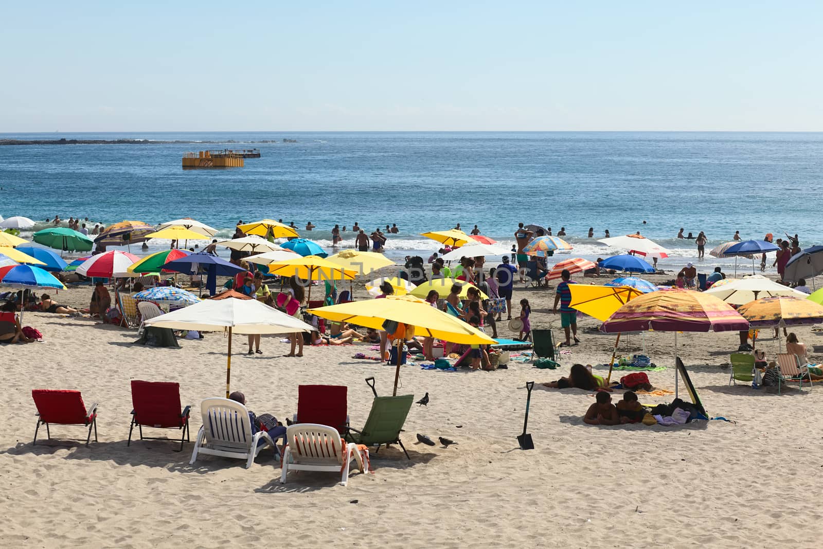 IQUIQUE, CHILE - JANUARY 23, 2015: Unidentified people on Cavancha beach on January 23, 2015 in Iquique, Chile. Iquique is a popular beach town and free port city in Northern Chile.