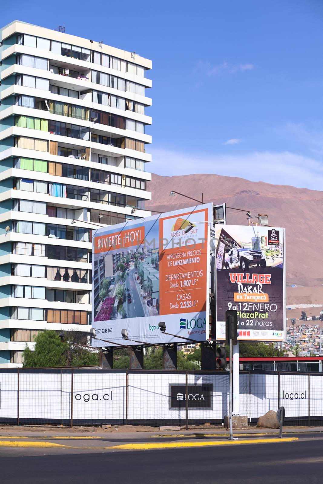 IQUIQUE, CHILE - JANUARY 23, 2015: Sign along Arturo Prat Chacon avenue informing about the construction and sale of new apartments and houses on January 23, 2015 in Iquique, Chile.