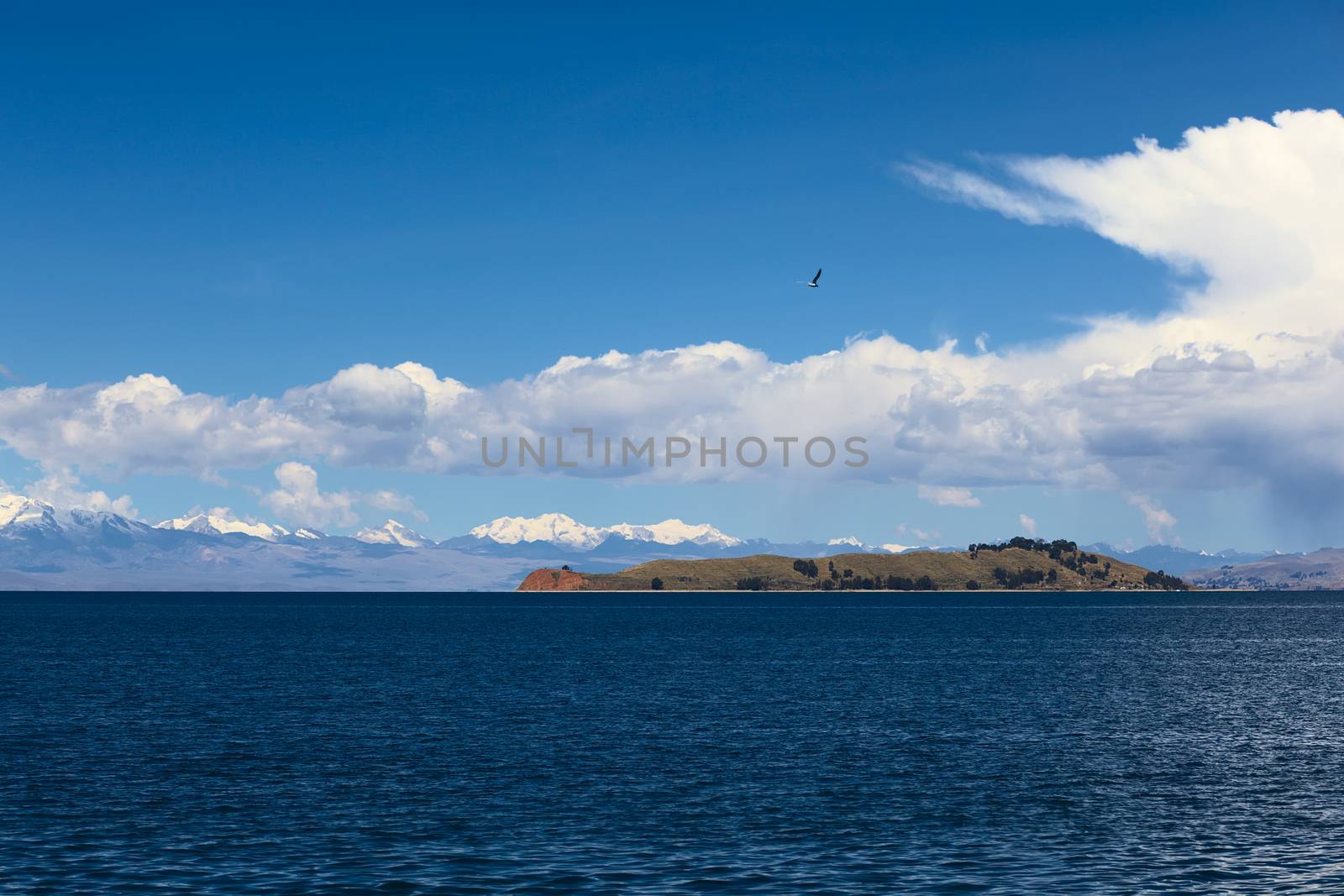 Isla de la Luna (Island of the Moon) in Lake Titicaca, Bolivia with the mountain range of the Andes in the back photographed from the popular tourist destination of Isla del Sol (Island of the Sun)