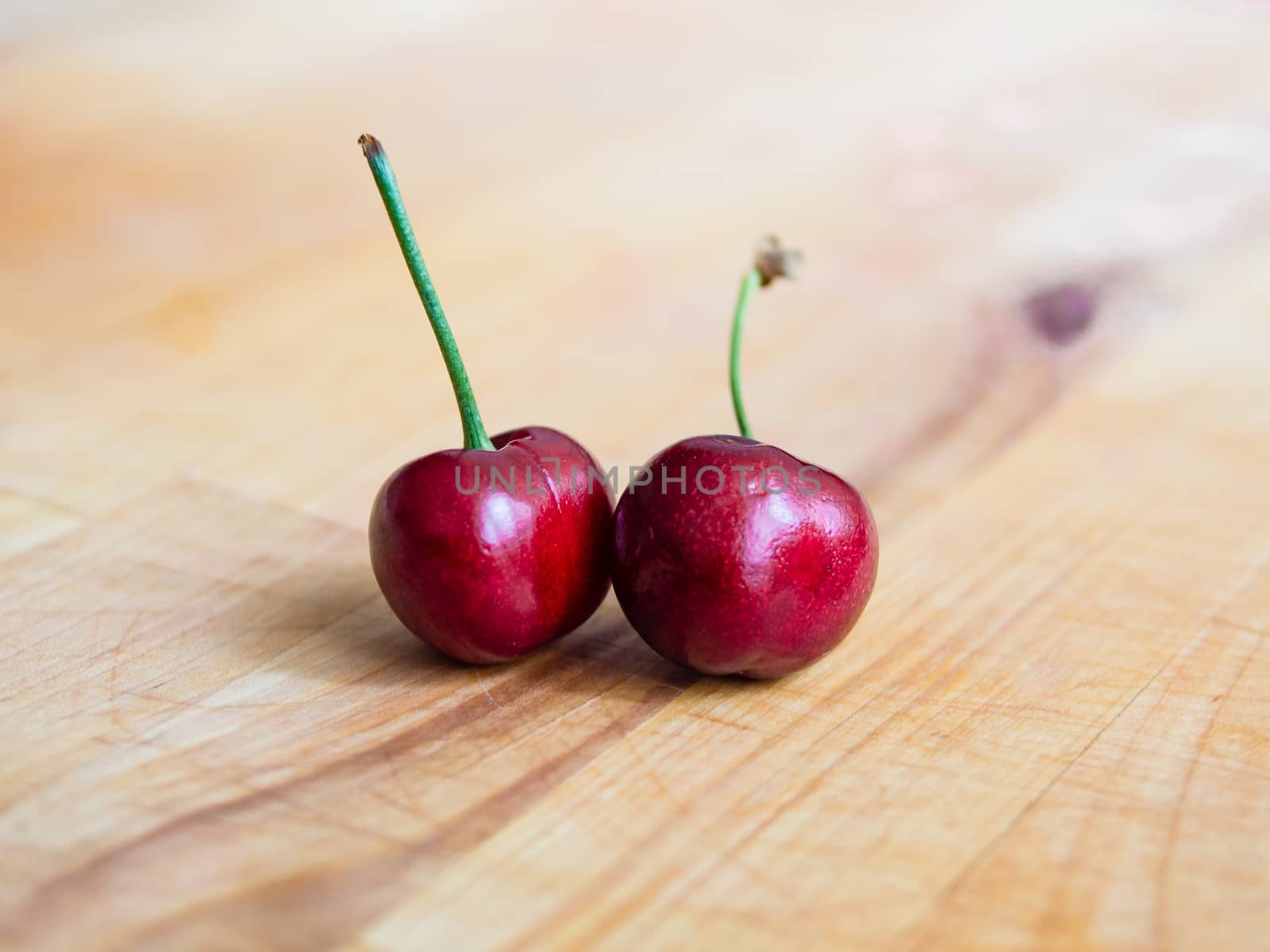 Pair of cherries on a plank by weruskak
