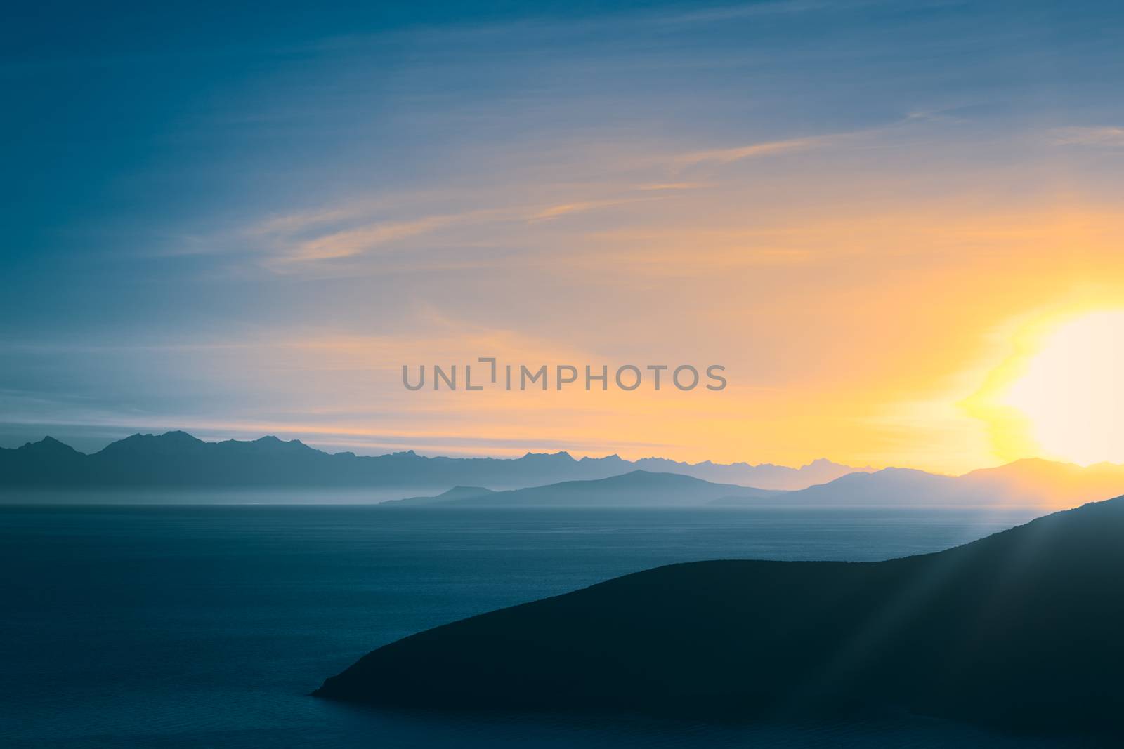 Sunrise over Lake Titicaca and the mountains of the Andes viewed from the popular tourist destination of Isla del Sol (Island of the Sun) in Lake Titicaca, Bolivia