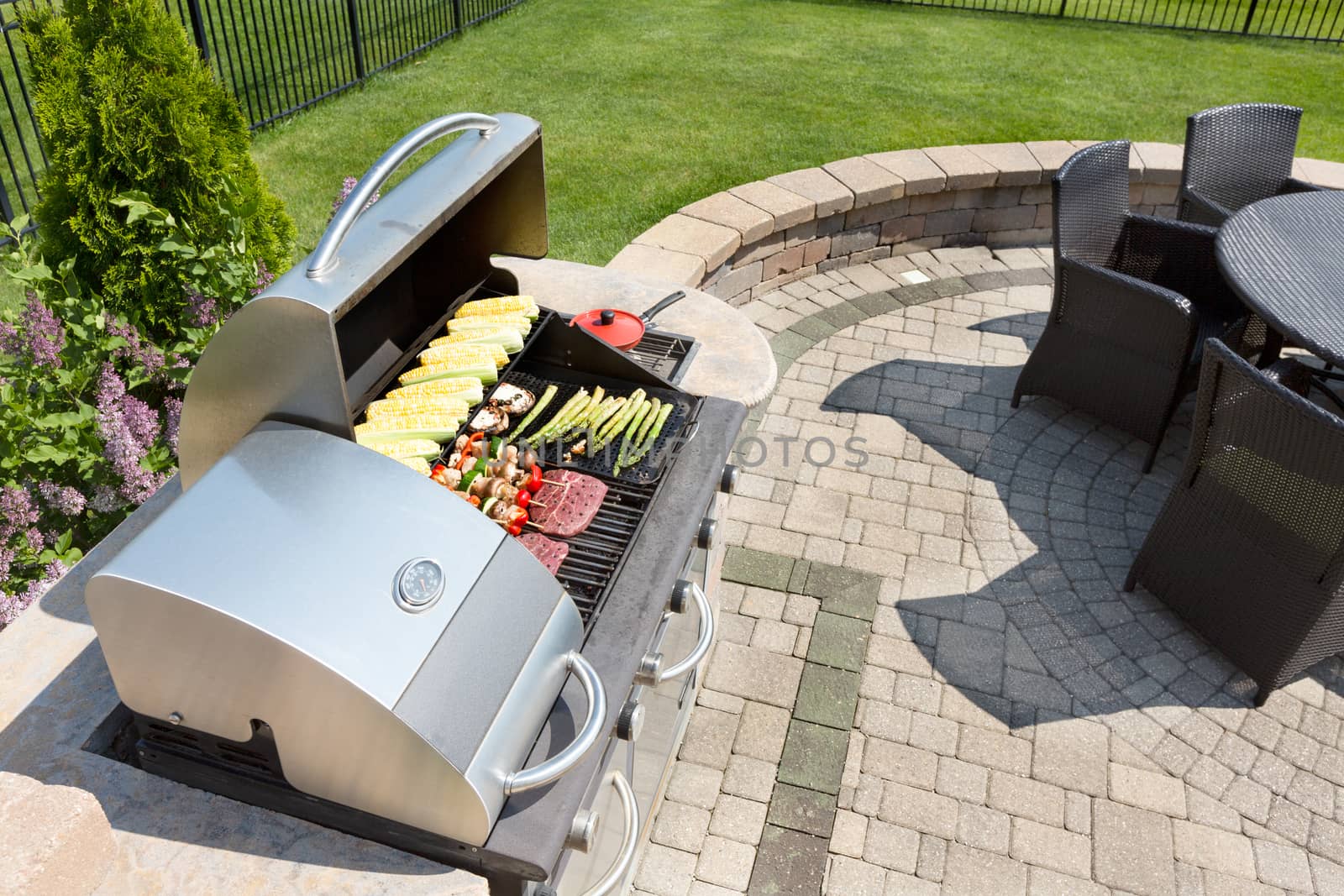 Grilling food on an outdoor gas barbecue by coskun