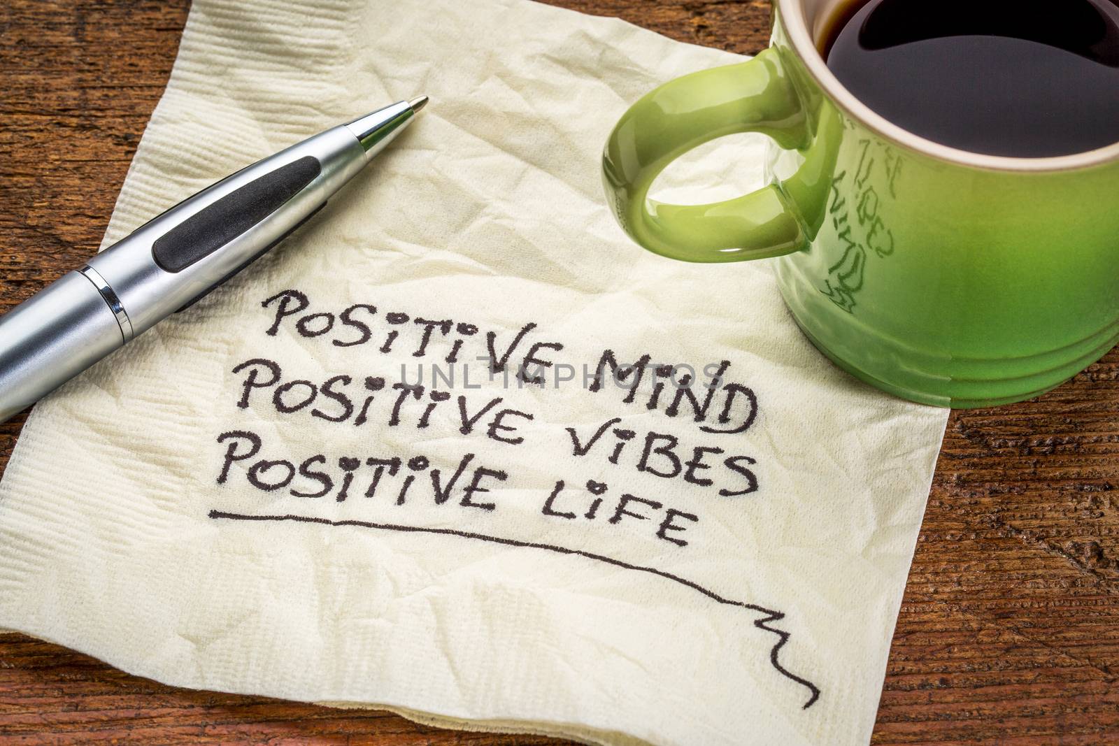 positive mind,  positive vibes, positive life - motivational handwriting on a napkin with a cup of coffee