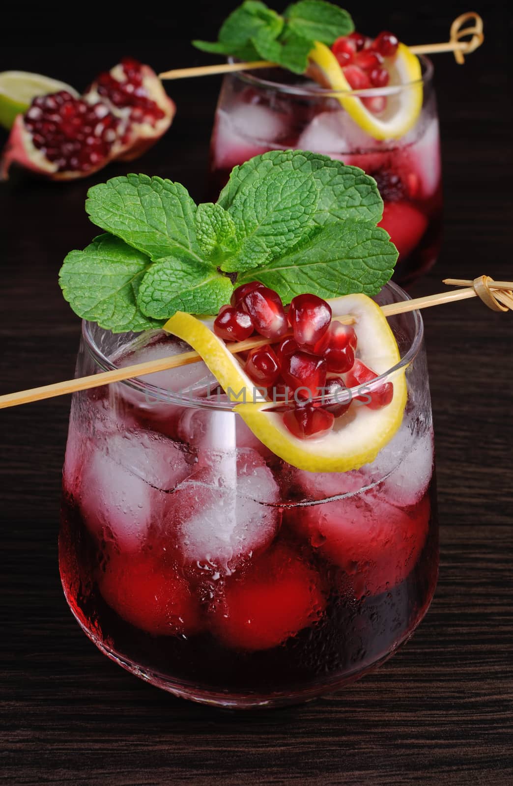 pomegranate drink with ice, a slice of lemon and mint