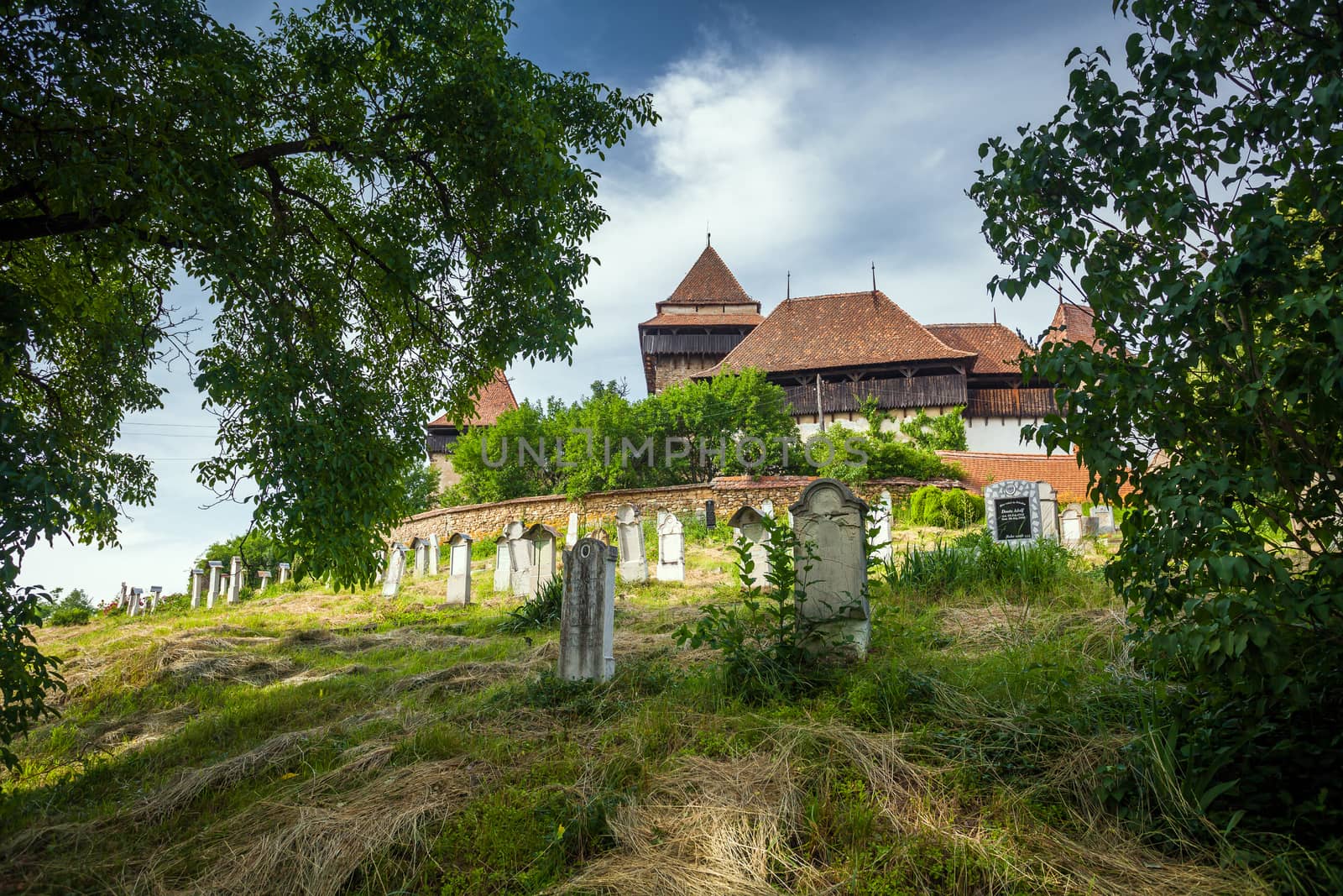 Viscri, Romania - June 23, 2013: Fortified Church cemetery at Viscri in Transylvania, Romania