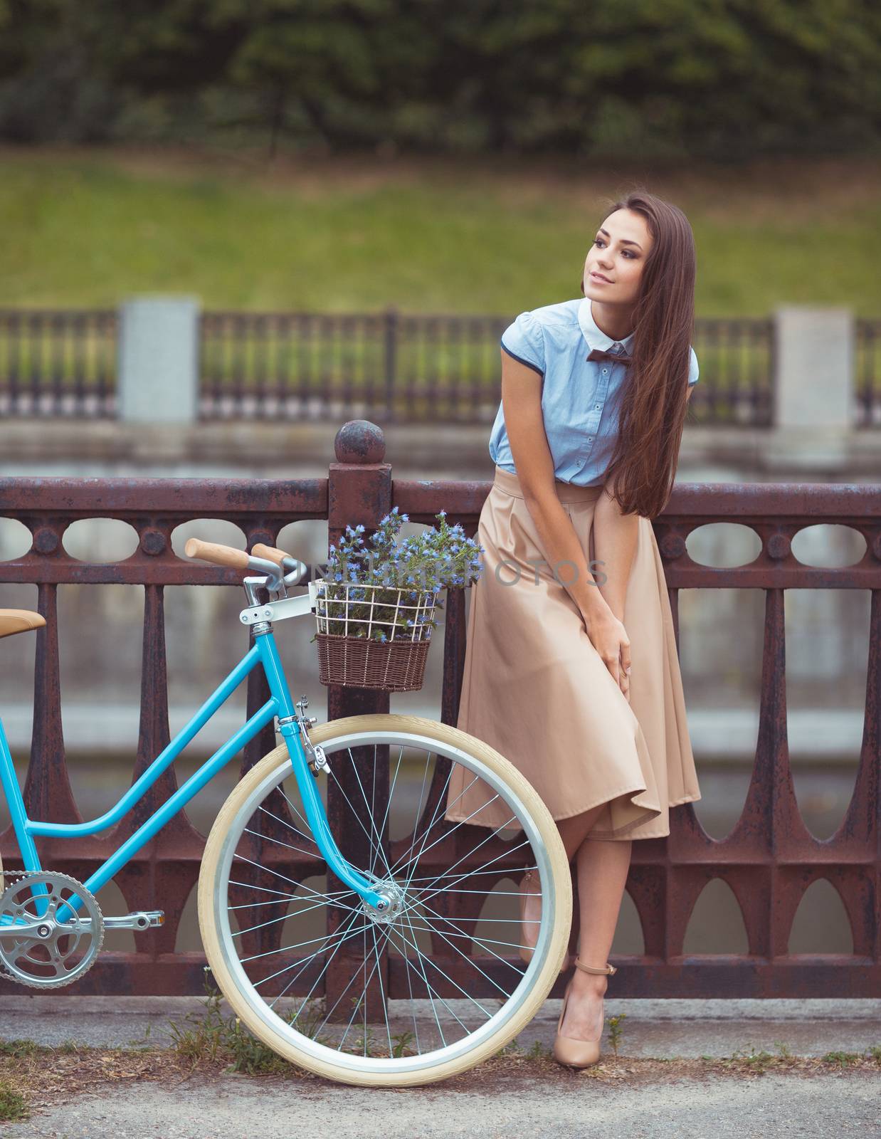 Young beautiful, elegantly dressed woman with bicycle. Beauty, fashion and lifestyle