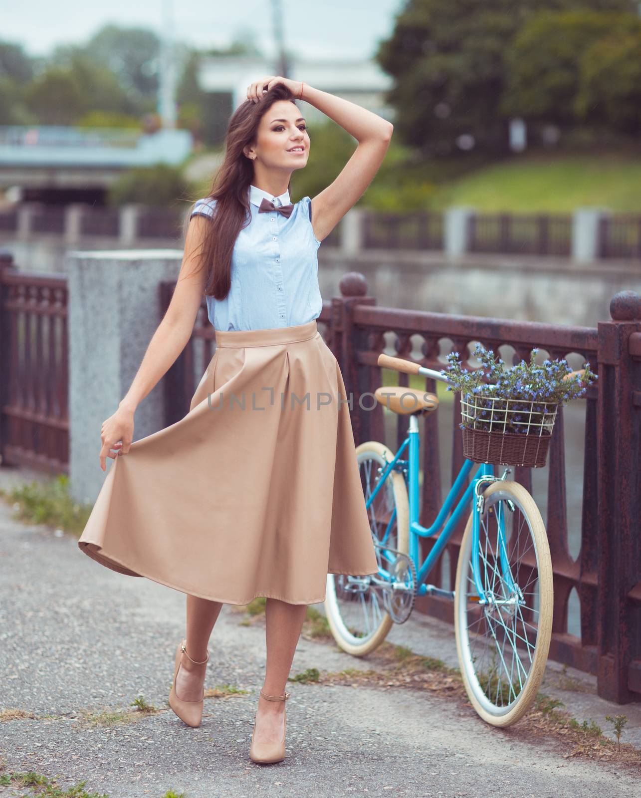 Young beautiful, elegantly dressed woman with bicycle. Beauty, fashion and lifestyle