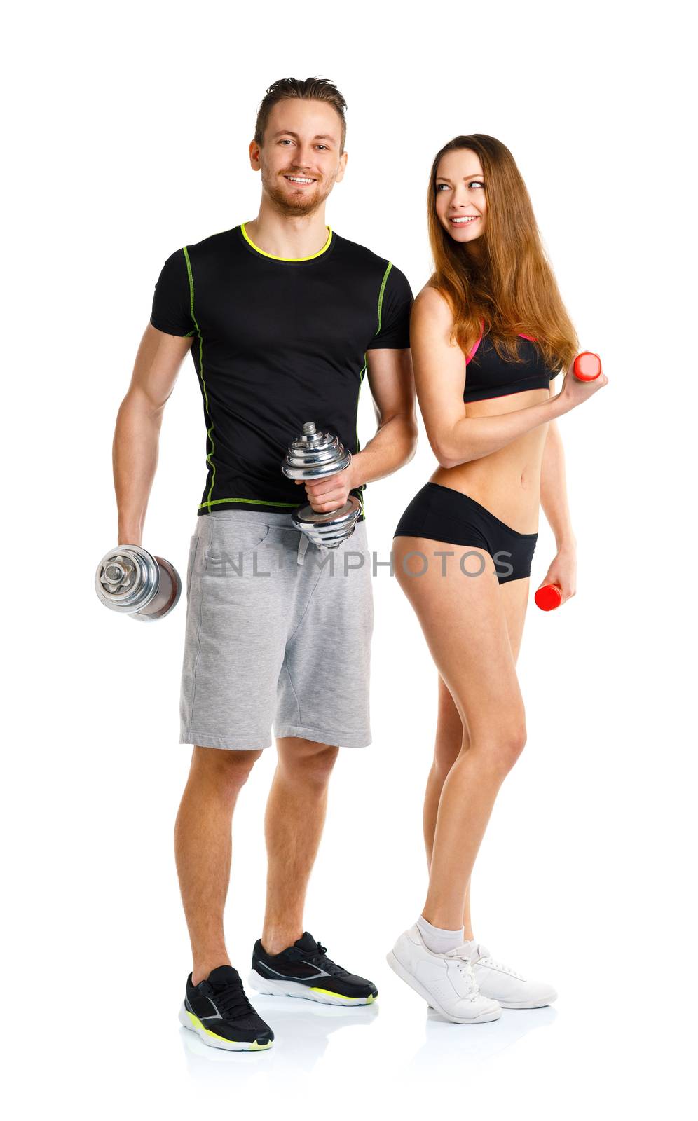 Sport couple - man and woman with dumbbells on the white background