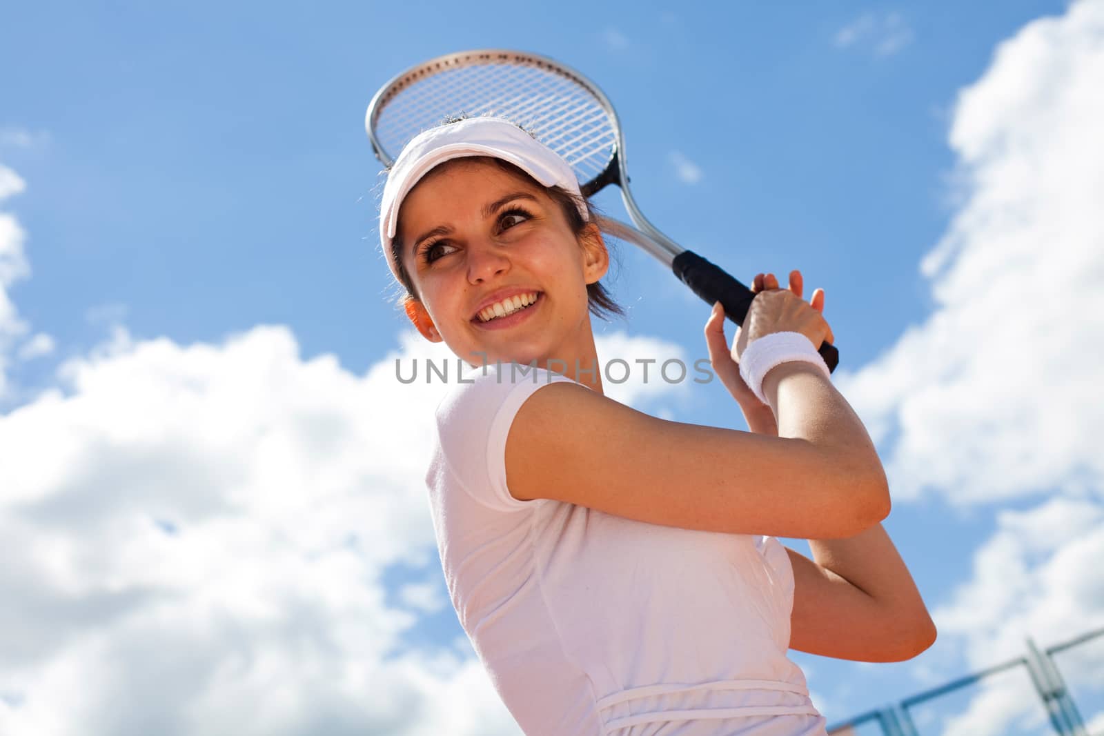 Woman playing tennis in summer