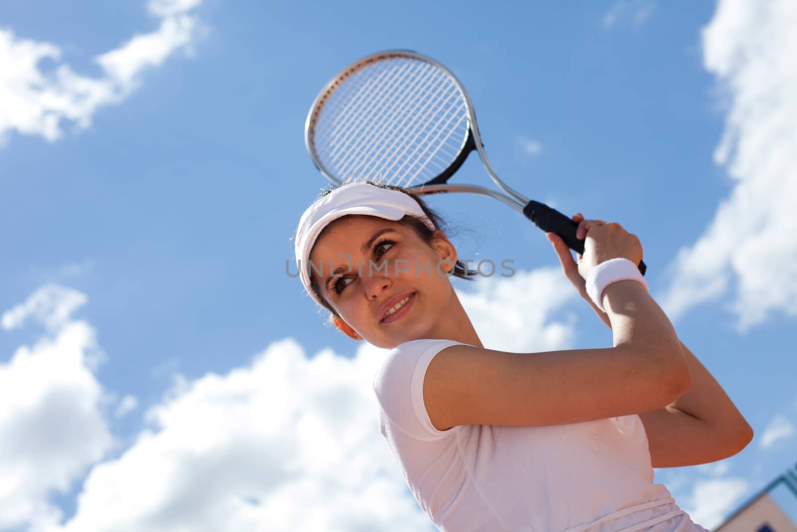 Woman playing tennis in summer