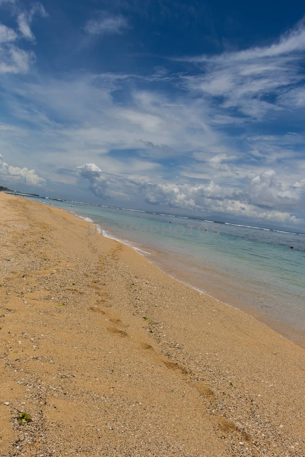 Beautiful tropical beach with lush vegetation by juniart