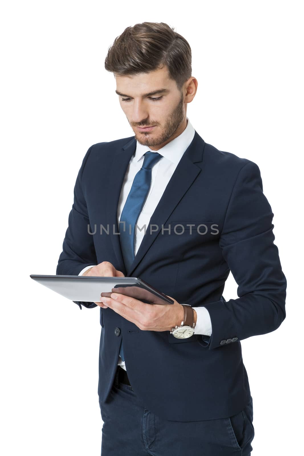 Businessman using a tablet computer navigating the touchscreen with his finger as he surfs the internet, close up view of his hands and the tablet, on white